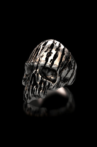 Three-quarter profile view of the men's Textured Silver Skull Ring, highlighting the skull's organic, carved pattern and deep eye sockets.
