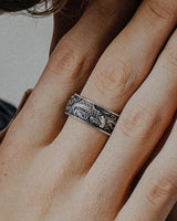 Silver Koi Fish Ring with detailed Japanese waves worn on a finger, showcasing the handcrafted oxidized finish and texture.