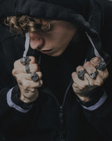 Model wearing the Silver Valknut Skull Ring as part of a gothic, biker-style outfit with a black hoodie.