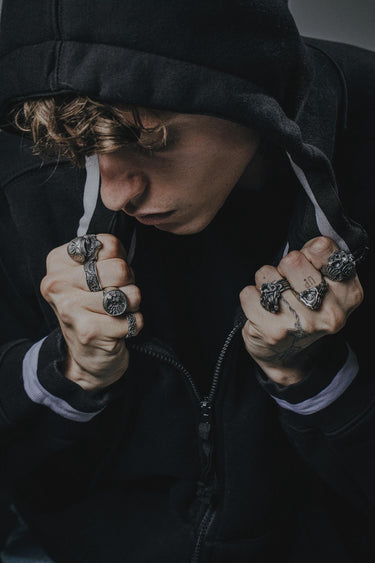 Model wearing the Silver Valknut Skull Ring as part of a gothic, biker-style outfit with a black hoodie.