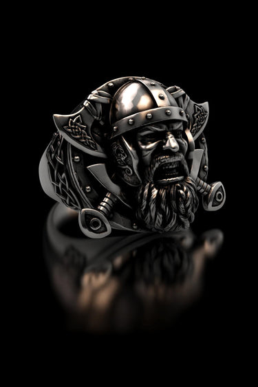 Angled view of the handcrafted silver Viking Warrior ring, detailing the Celtic knotwork on the axes and 3D helmet.