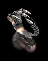 Studio product shot of the Dragon Claw Ring in 925 sterling silver on a black background, highlighting the polished claws.