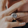 Man wearing a sterling silver statement ring, embodying a bold and edgy aesthetic ideal for our gothic biker collection.
