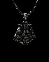 Detailed view of handcrafted Norse raven pendant showing Celtic knotwork and wolf head design in oxidized silver