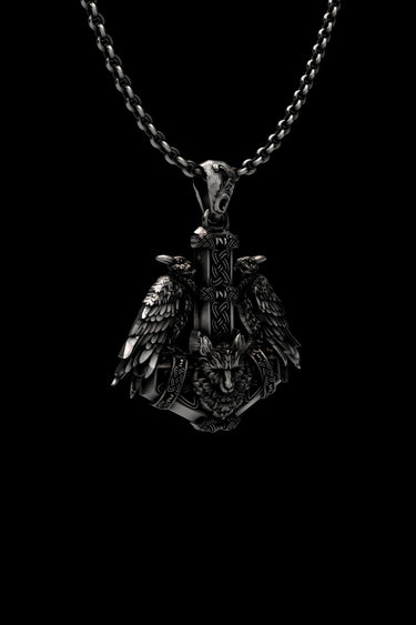 Detailed view of handcrafted Norse raven pendant showing Celtic knotwork and wolf head design in oxidized silver