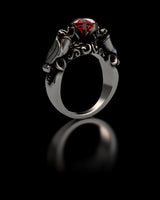 Front view of the 925 sterling silver bat ring, highlighting the symmetrical vampire bats and brilliant red stone setting.