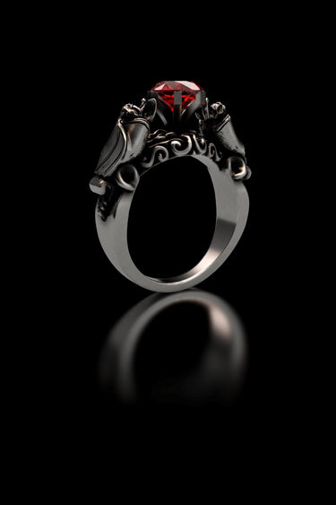 Front view of the 925 sterling silver bat ring, highlighting the symmetrical vampire bats and brilliant red stone setting.
