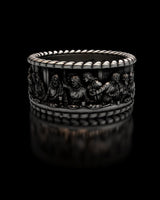 Detailed studio view of the Last Supper Ring in 925 sterling silver, showcasing the sculpted figures on a black background.