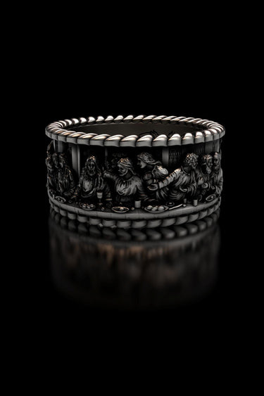 Detailed studio view of the Last Supper Ring in 925 sterling silver, showcasing the sculpted figures on a black background.
