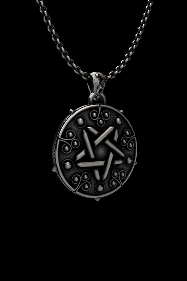 Detailed close-up view of handcrafted pentagram pendant showing oxidized finish and intricate sorceress symbols