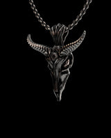 Side angle view of oxidized silver Baphomet pendant displaying intricate carved patterns and textured horn details