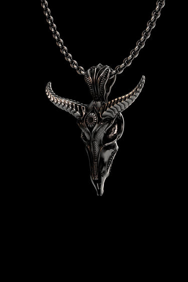 Side angle view of oxidized silver Baphomet pendant displaying intricate carved patterns and textured horn details