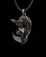 Silver rhino pendant in 925 sterling silver, showing the detailed textured hide and polished horn on a chain.