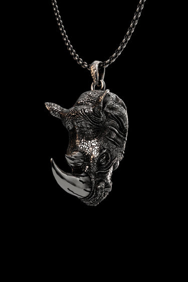 Silver rhino pendant in 925 sterling silver, showing the detailed textured hide and polished horn on a chain.