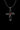 Silver infinity cross pendant with three red garnets on a sterling silver chain, shown against a black background.