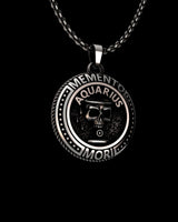 Close-up view of handcrafted Aquarius pendant showing oxidized detailing and sterling silver craftsmanship