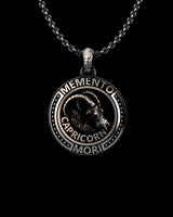 Angled view of the handcrafted Capricorn skull pendant for men, showing the oxidized finish and intricate relief details.