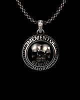 Close-up view of handcrafted Gemini pendant displaying oxidized silver finish and inscribed border text details