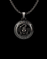 Close-up view of oxidized sterling silver Scorpio pendant displaying intricate memento mori relief details