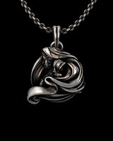 Close-up view of handcrafted goddess pendant showing oxidized silver finish and sculptural wave details