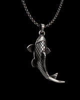 Close-up view of handcrafted Japanese carp pendant showing intricate scale details and oxidized finish