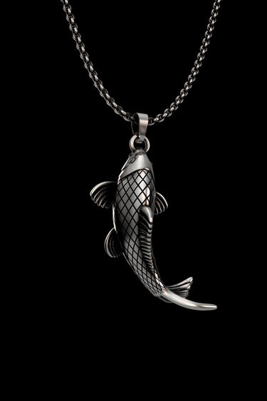 Close-up view of handcrafted Japanese carp pendant showing intricate scale details and oxidized finish