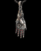 Close-up of mystical hand pendant displaying intricate textures and ornate finger details in sterling silver