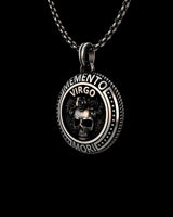 Close-up view of oxidized sterling silver Virgo medallion displaying intricate floral skull craftsmanship