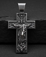 925 sterling silver Jesus cross pendant with black rhodium finish and detailed religious carving on dark background