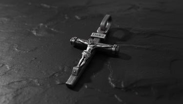 Side angle view of handcrafted crucifix pendant showing oxidized finish and three-dimensional Jesus detail