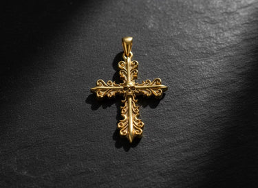 Detailed view of ornate cross pendant showing intricate scrollwork and skull motif in premium sterling silver