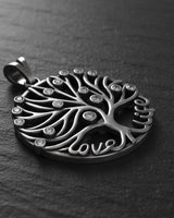 Side angle view of oxidized silver tree pendant showing dimensional branches and sparkling CZ stone details