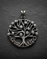 925 sterling silver tree of life pendant with Love Life text and cubic zirconia stones on dark slate background