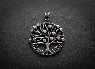 925 sterling silver tree of life pendant with Love Life text and cubic zirconia stones on dark slate background