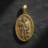Gold vermeil Saint Roch pendant with detailed religious engraving on dark textured background showing Catholic medal