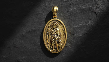 Gold vermeil Saint Roch pendant with detailed religious engraving on dark textured background showing Catholic medal