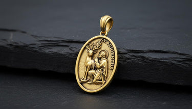Side angle view of handcrafted Saint Hubert medal displaying intricate religious metalwork and oval shape