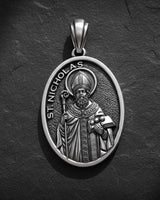 Saint Nicholas pendant in gold vermeil finish showing detailed bishop design on dark textured background