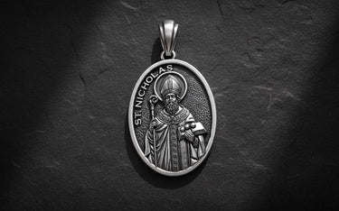 Saint Nicholas pendant in gold vermeil finish showing detailed bishop design on dark textured background