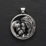925 sterling silver lion family pendant showing parents and cub in protective embrace on dark slate background