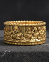 Close-up view of religious Last Supper ring with rope border and intricate biblical scene metalwork craftsmanship