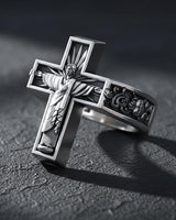Side angle view of sacred heart cross ring showing detailed Jesus figure with radiating light rays and scrollwork