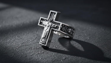 Side angle view of sacred heart cross ring showing detailed Jesus figure with radiating light rays and scrollwork