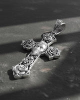 Close-up view of handcrafted tattoo-style cross pendant featuring detailed metalwork and gothic religious symbolism