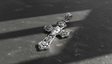 Close-up view of handcrafted tattoo-style cross pendant featuring detailed metalwork and gothic religious symbolism