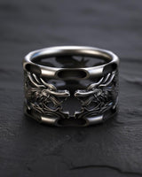 925 sterling silver dragon ring with dual dragon heads and oxidized finish on dark slate background