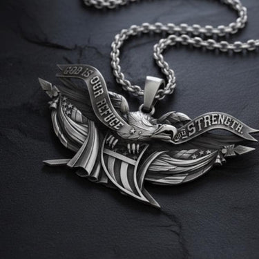 Close-up of handcrafted sterling silver eagle pendant displaying oxidized finish and banner text details