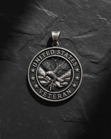 Handcrafted veteran pendant in sterling silver with detailed eagle wings and United States inscription detail view