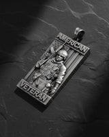 Close-up detail of handcrafted American Veteran pendant displaying oxidized finish and intricate tactical equipment