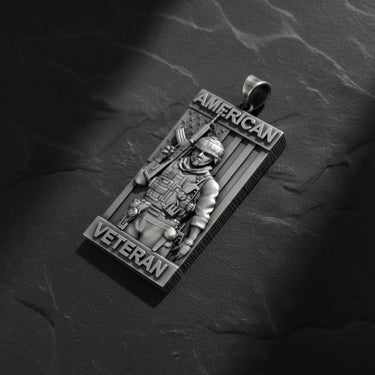 Close-up detail of handcrafted American Veteran pendant displaying oxidized finish and intricate tactical equipment